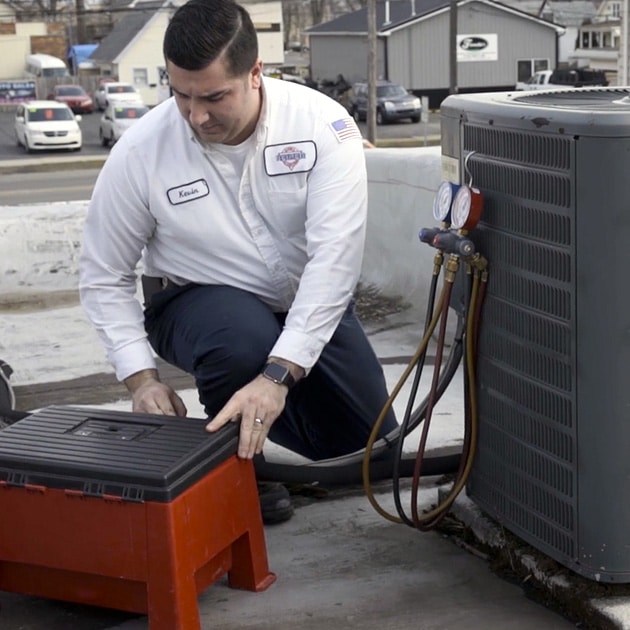 This Reimer AC expert works on this local air conditioner as part of a springtime tune-up.