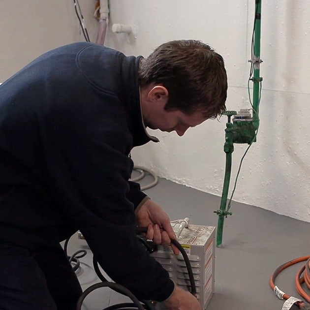 Our plumber finishes setting up pipe-thawing equipment in this Buffalo home with frozen pipes.