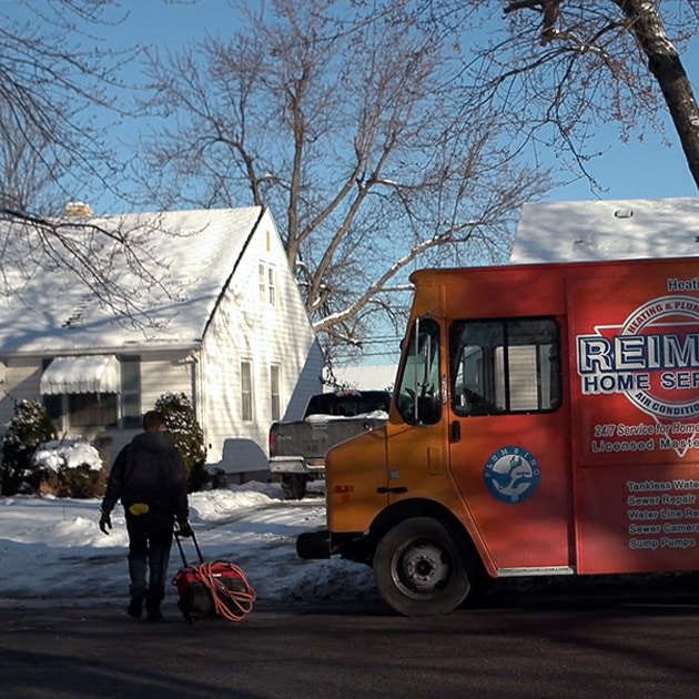 On a cold winter morning, a Reimer plumber walks to a home with frozen pipes here in Buffalo.