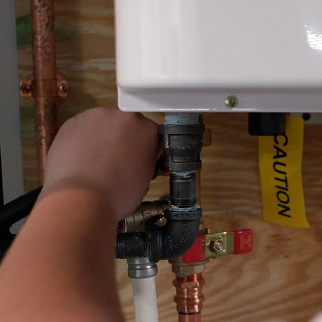 One of our plumbers tightens a pipe connecting as part of a plumbing repair call in Cheektowaga.