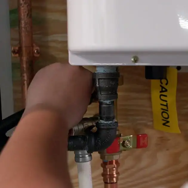 One of our plumbers tightens a pipe connecting as part of a plumbing repair call in Cheektowaga.