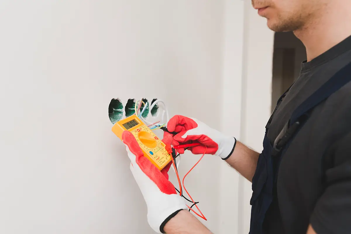 Electrician measuring voltage