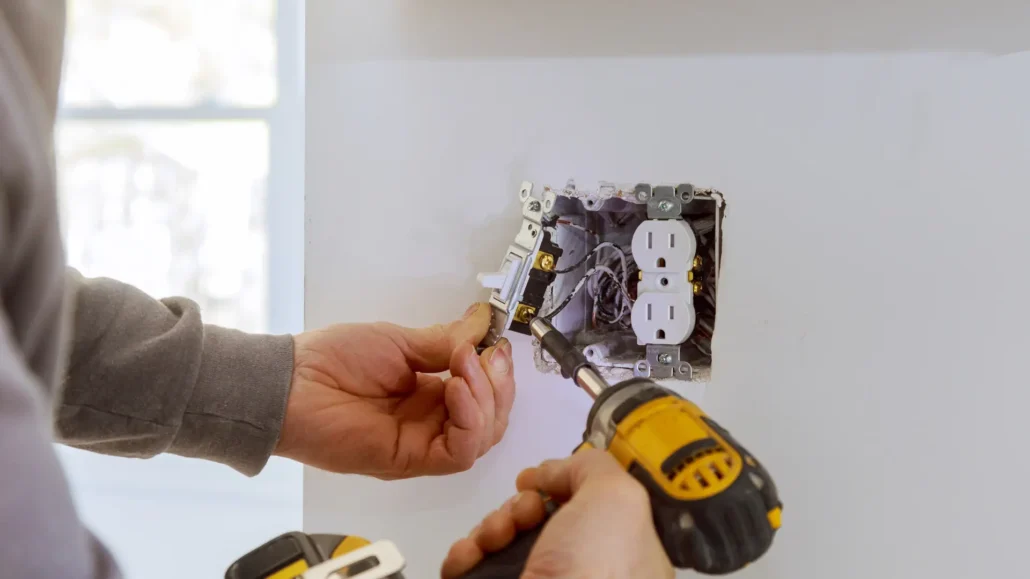 A close-up of a new modern wall outlet being installed in a clean home interior.