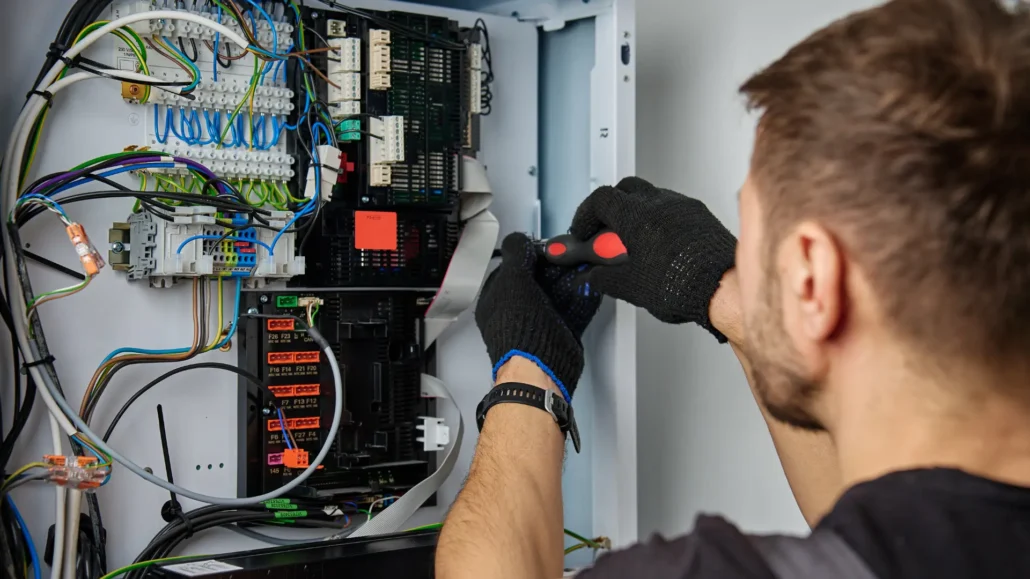 An electrician troubleshooting a residential electrical issue using testing equipment