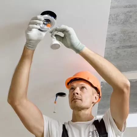 electrician installing a light